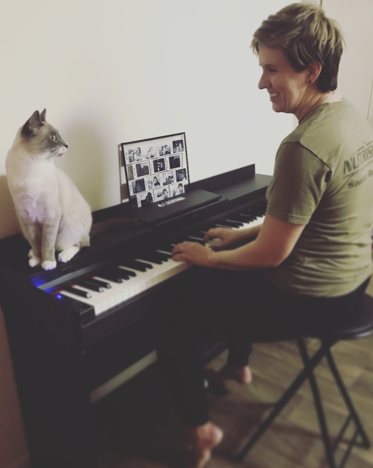 Kayla at the piano with her cat